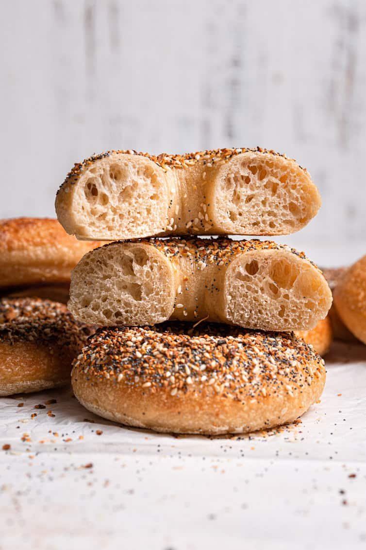 A bagel cut in half stacked on top of one another.
