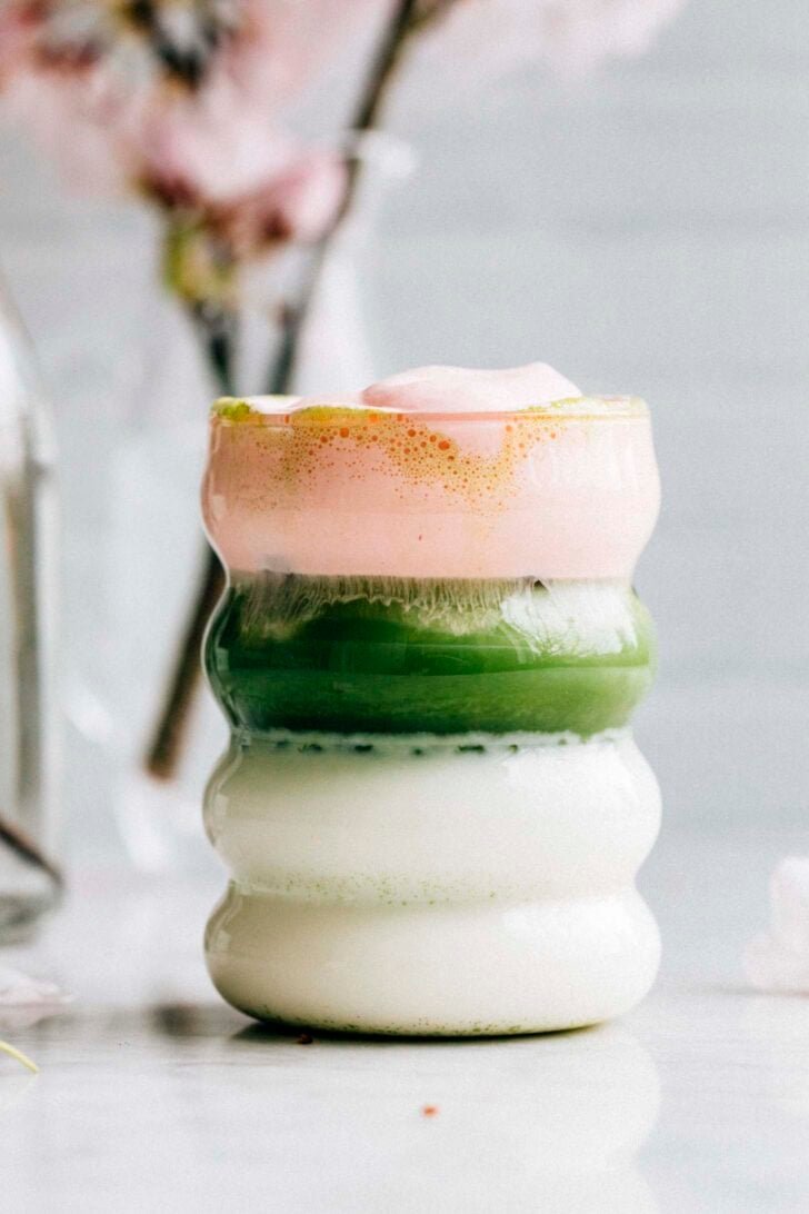 photo of sakura matcha latte in a wavy glass