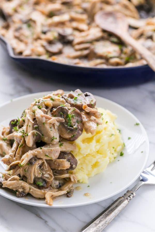 Turkey in Gravy is one of all all-time favorite leftover turkey recipes. Turkey in creamy mushroom sauce is so easy and always disappears fast. #leftoverturkey #leftoverturkeyrecipes #turkeyingravy #mushroomgravy #gravy #turkey Leftover turkey recipe served over mashed potatoes