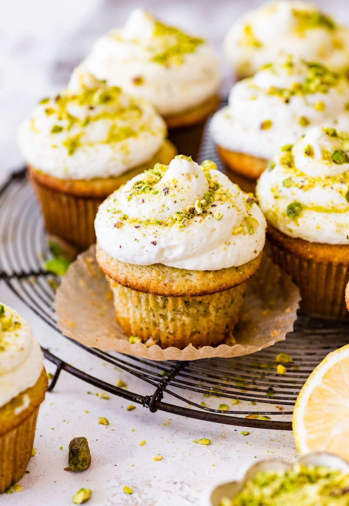 lemon pistachio cupcakes on cooling rack.