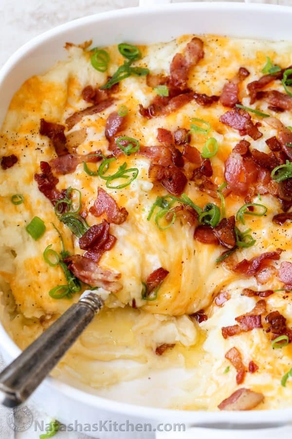 Loaded Mashed Potato Casserole topped with cheese, bacon and chives