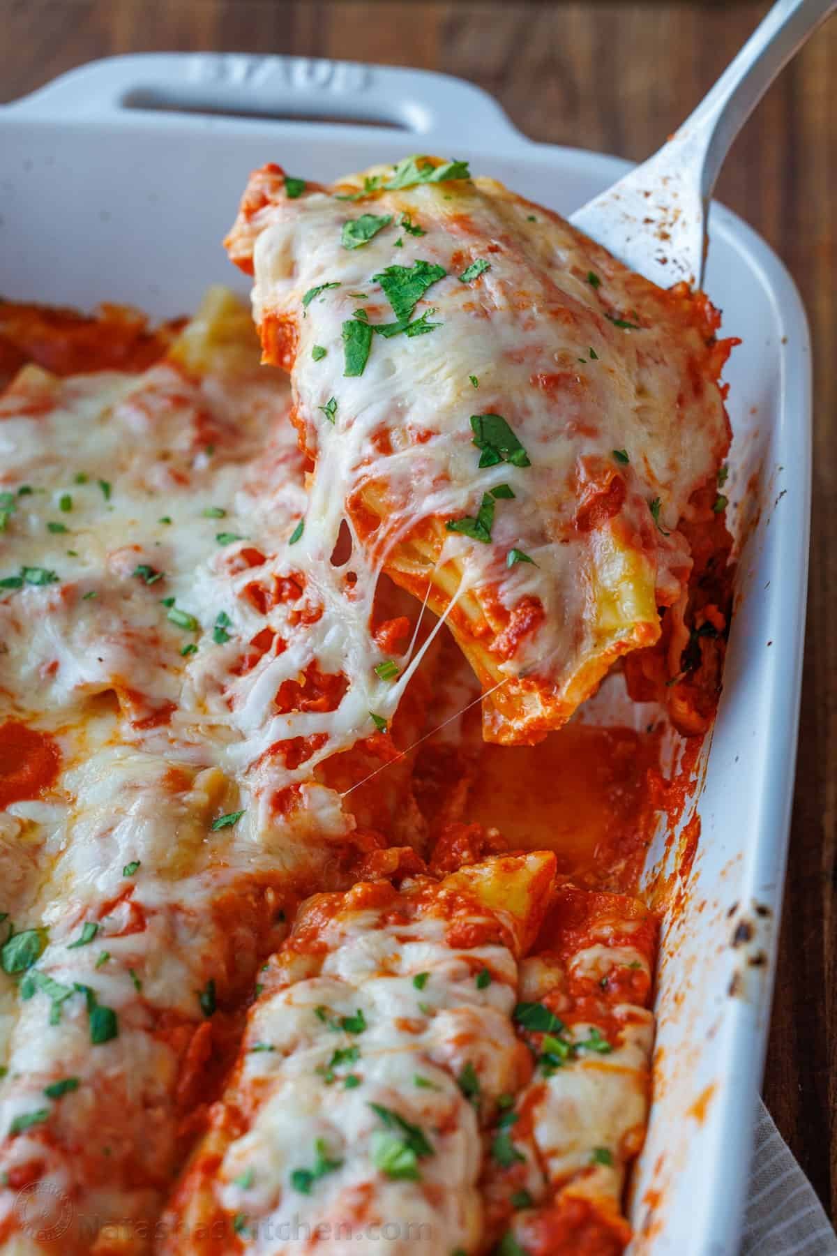 Our Stuffed Manicotti recipe has three delicious cheeses stuffed into perfectly cooked pasta, smothered in marinara sauce and baked perfectly. the best Manicotti recipe with three cheeses and homemade marinara sauce