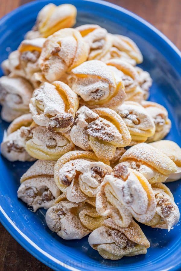 Meringue Shell Cookies have a crisp ribbon of meringue and soft crumbly center. These walnut meringue cookies are completely irresistible Christmas cookies! | natashaskitchen.com