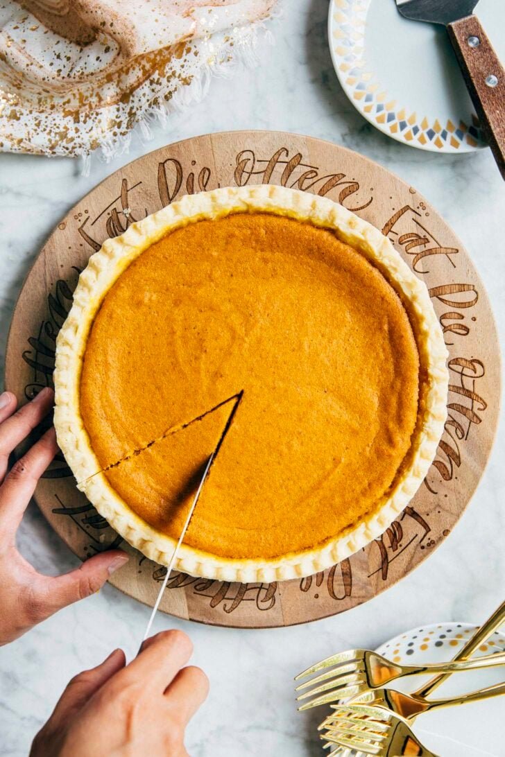photo of cream cheese pumpkin pie being sliced by michelle of hummingbird high