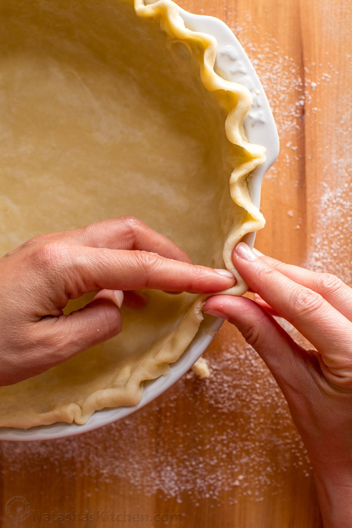 This homemade Pie Crust recipe yields a flaky, tender crust with rich buttery flavor. An easy pie dough - perfect for sweet or savory pies. Pie Crust in a white pie dish