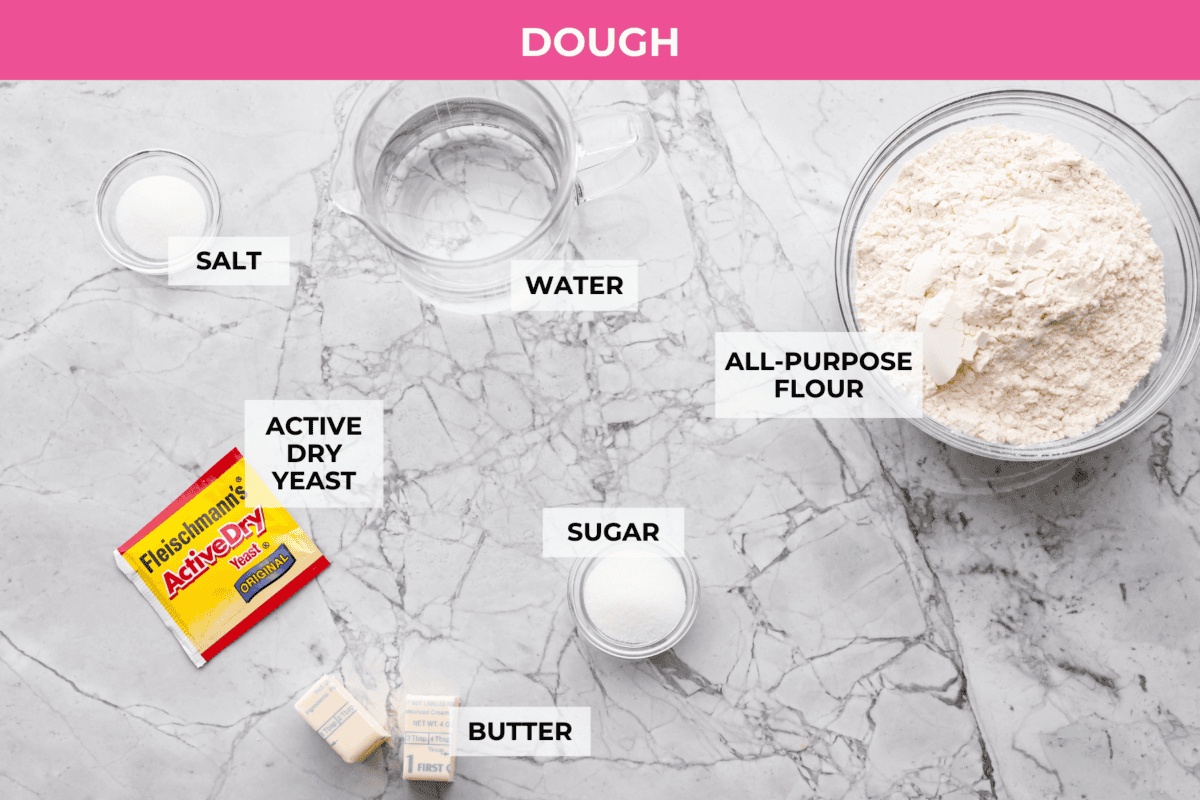You’ll love these copycat Pizza Hut breadsticks with a fluffy, soft inside and crispy, buttery outside, all topped with delicious seasoning, Parmesan, and melted butter! Overhead shot of labeled pizza hut breadsticks dough ingredients.