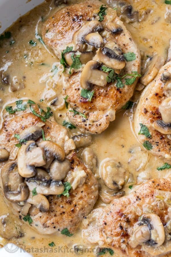 Pork chops recipe smothered in creamy mushroom sauce and garnished with parsley