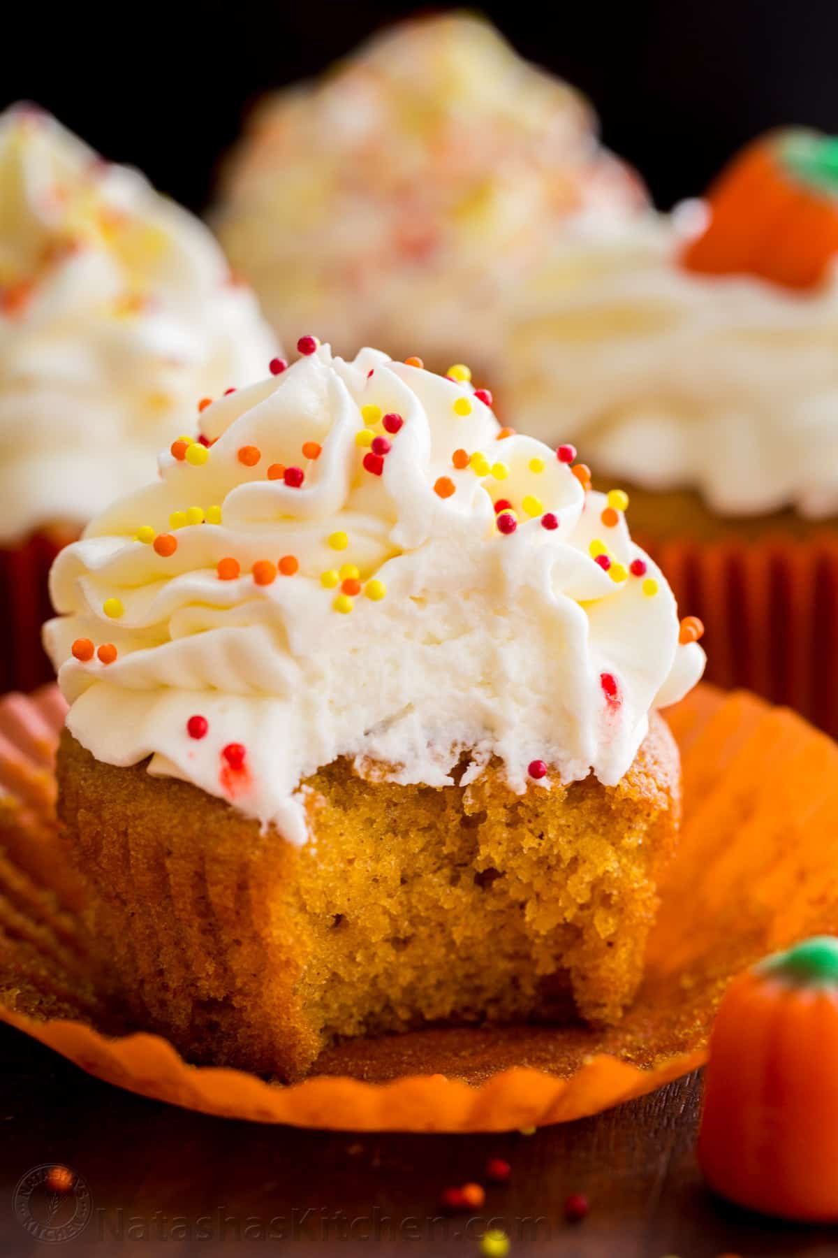 Taste the best pumpkin cupcake ever! It's a moist spiced pumpkin cupcake recipe with cream cheese frosting that bakes up quickly and easily. Cupcake using the best pumpkin cupcake recipe with cream cheese frosting and a bit eout of the cupcake