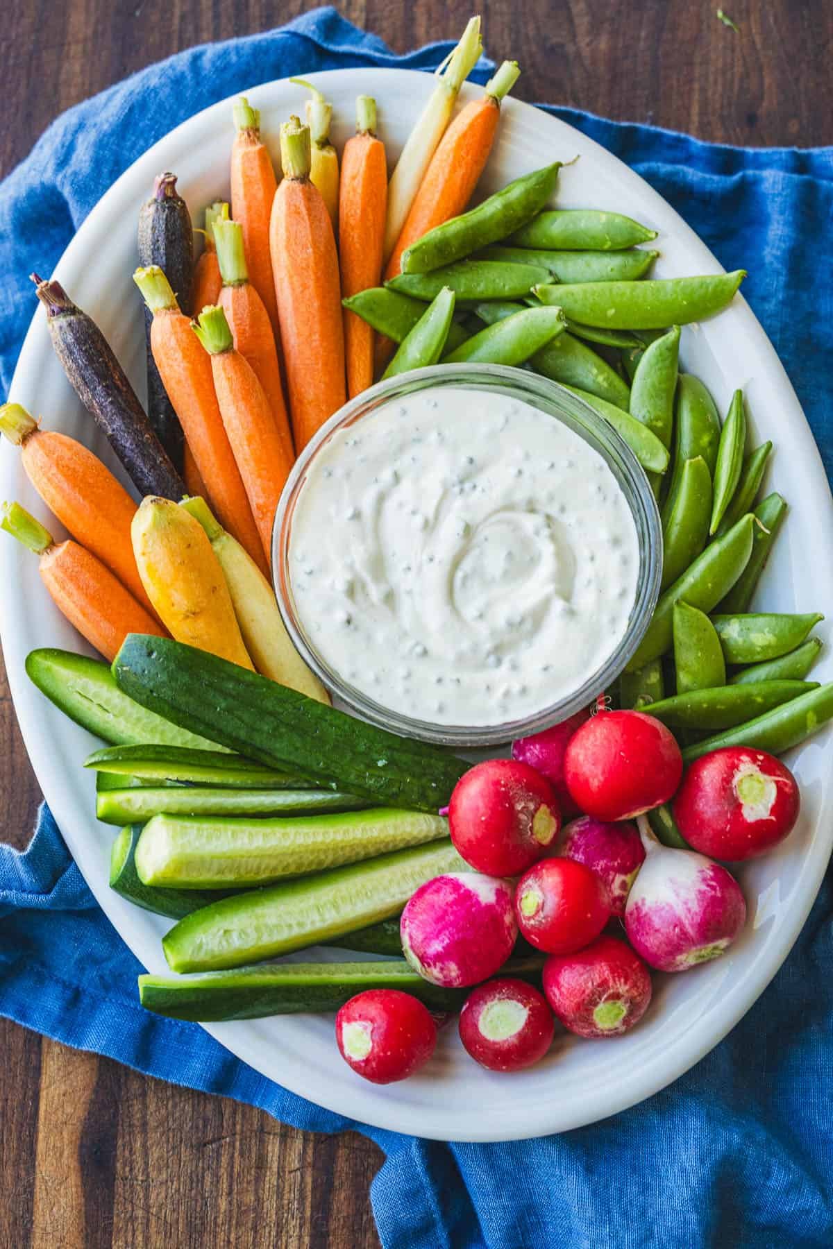 Easy Ranch Dip Recipe is ready in under 5 minutes with the best flavor and perfect thickness for dipping fresh vegetables and finger foods. Vegetable platter with Ranch dip on a blue towel