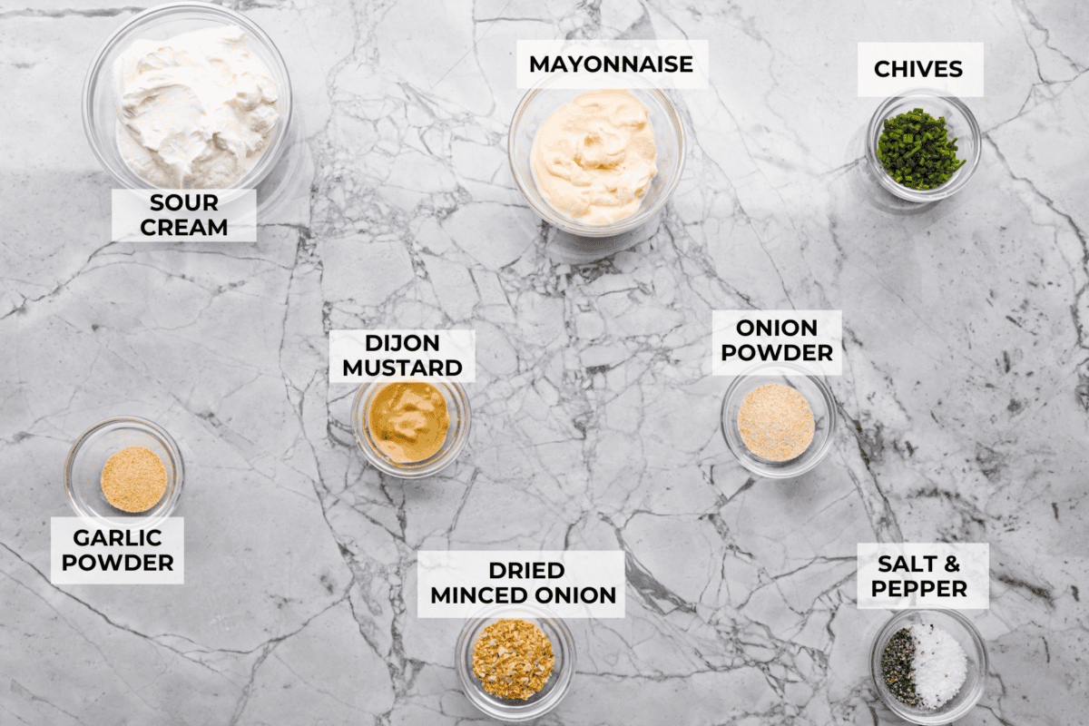 This sour cream and onion dip has become a staple at all of our family get togethers. It's the perfect appetizer, even the kids cant get enough! The rich and creamy dip is packed with incredible onion flavor. Overhead shot of labeled ingredients.