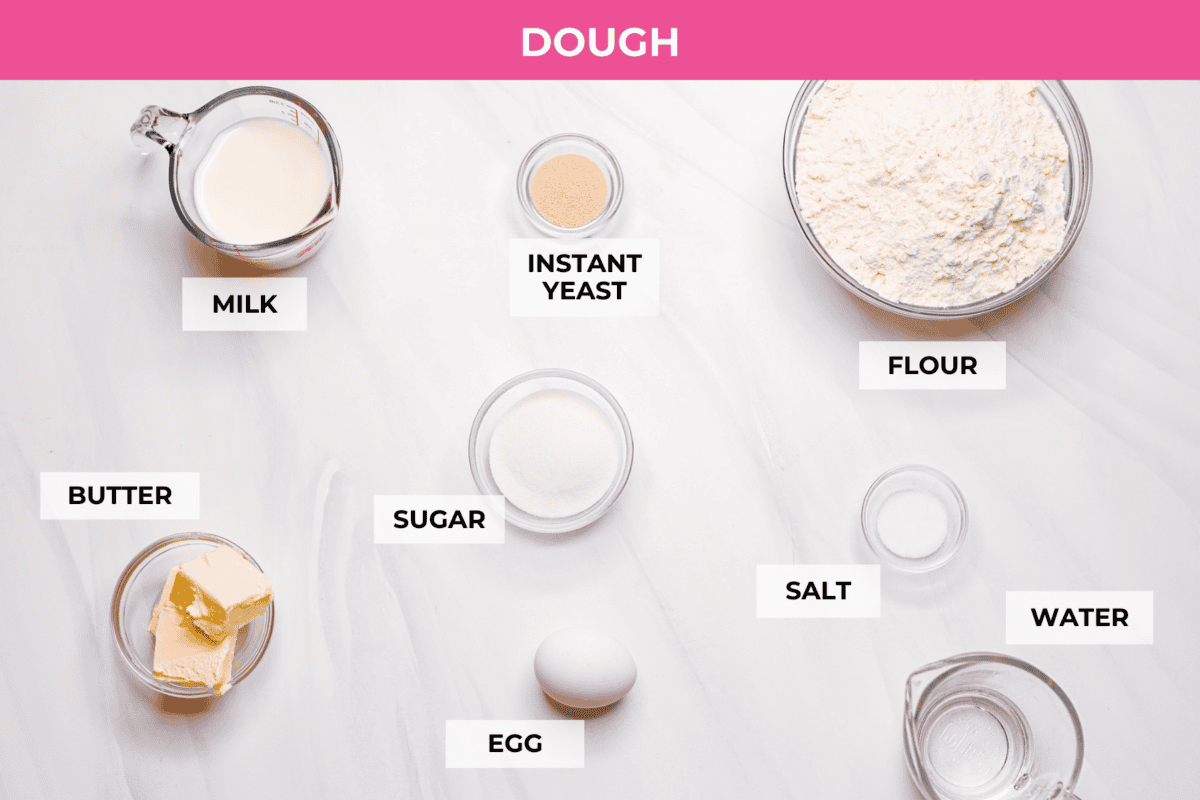 Strawberry cinnamon rolls are going to become a tradition in your house after you make these! The secret is the freeze-dried strawberries mixed with the lemon zest in the glaze - the flavor is to die for! Overhead shot of labeled strawberry cinnamon roll dough ingredients.