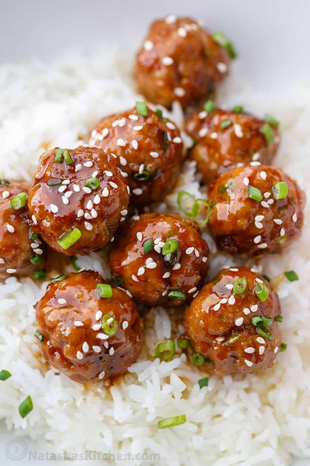 30-minute Turkey Teriyaki Meatballs are just as juicy with less guilt! Simply bake the meatballs and cover them with homemade teriyaki glaze. Teriyaki meatball recipe served over white rice
