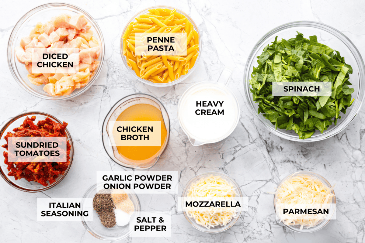 You all love my Crockpot Tuscan Chicken, and I know casseroles are a favorite as well. So, I combined them into this irresistibly delicious Tuscan Chicken Casserole! Overhead shot of labeled ingredients.