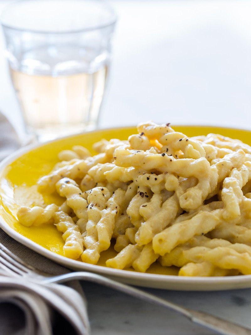 Vegan Cauliflower A close up of vegan cauliflower cream sauce on pasta with a fork and drink.