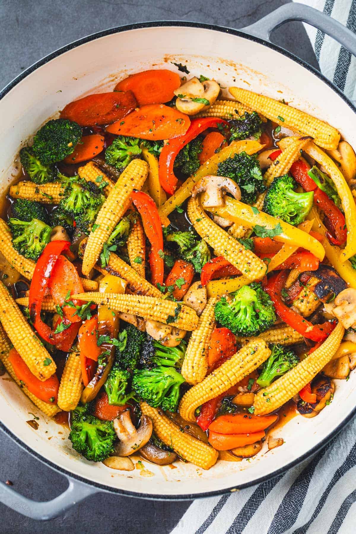 Vegetable Stir Fry in a Dutch oven with mixed veggies - carrots, baby corn, mushrooms, red peppers, and broccoli