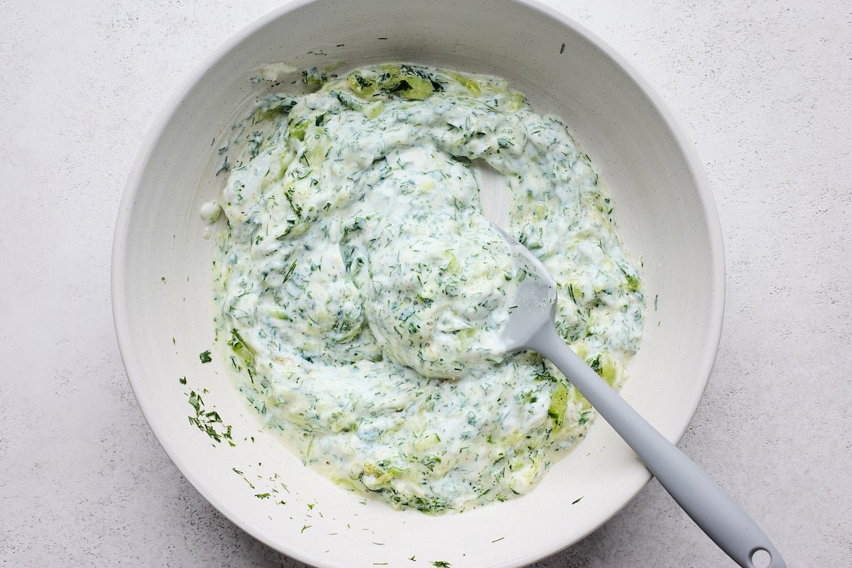 tzatziki sauce in bowl with spatula.