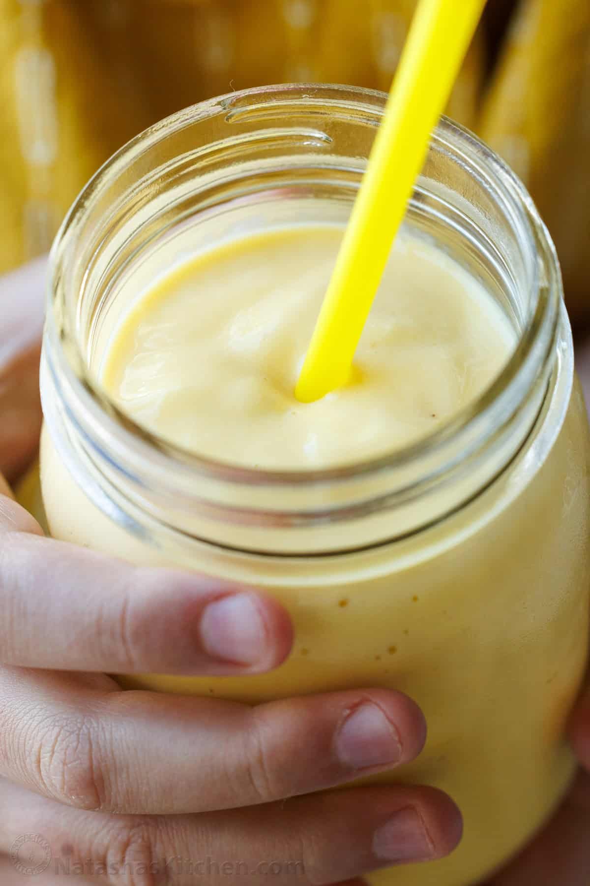 Easy Tropical Mango Smoothie recipe uses just 6 ingredients, like mango, lime, banana, and Greek yogurt, and takes under 5 minutes to make! Mango Lime breakfast smoothie in a mason jar with a yellow straw