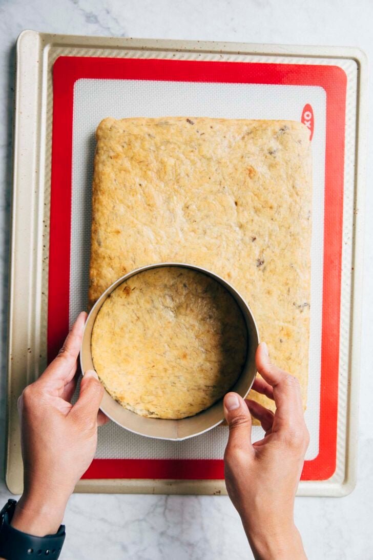 photo of Michelle from Hummingbird High using a cake ring to stamp out the banana cake layers from the sheet cake