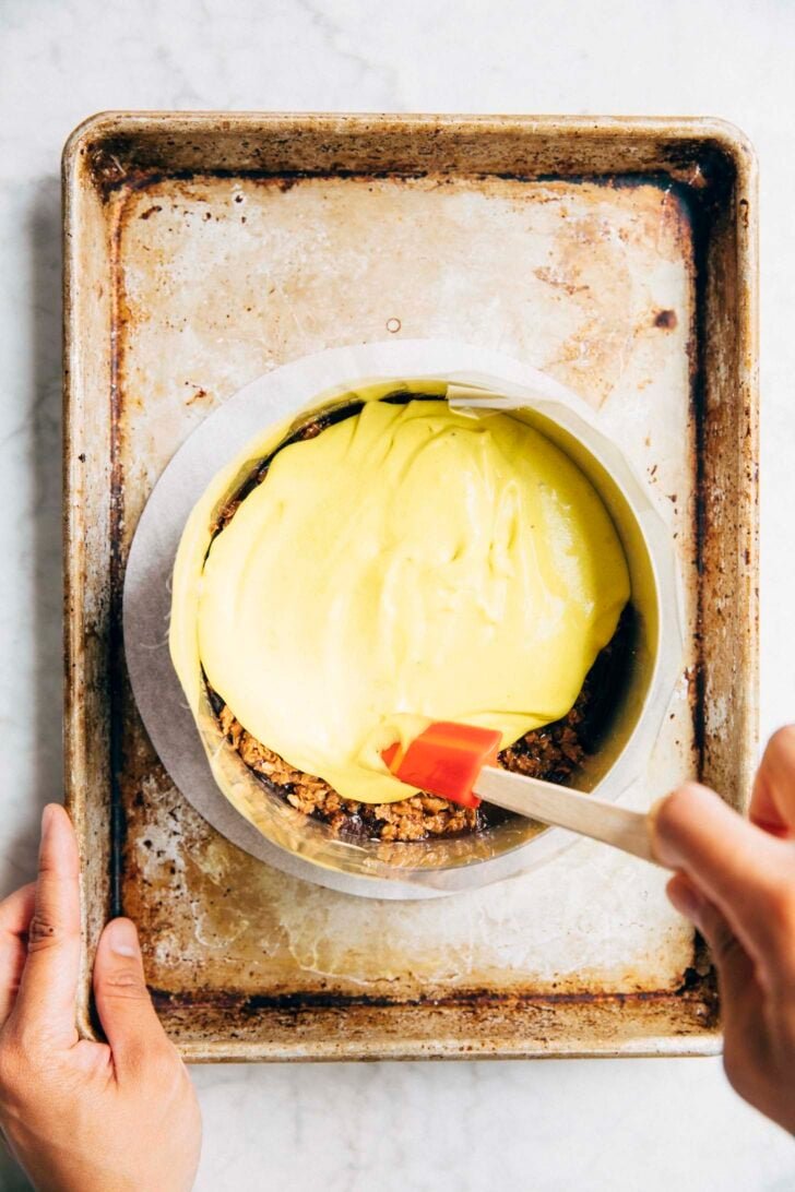 photo showing the ganache and crunch being topped with banana cream pudding