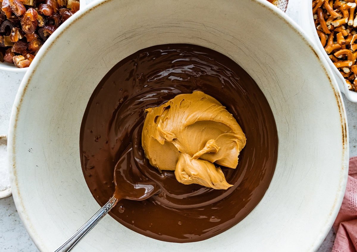 melted chocolate and peanut butter in mixing bowl with spoon.