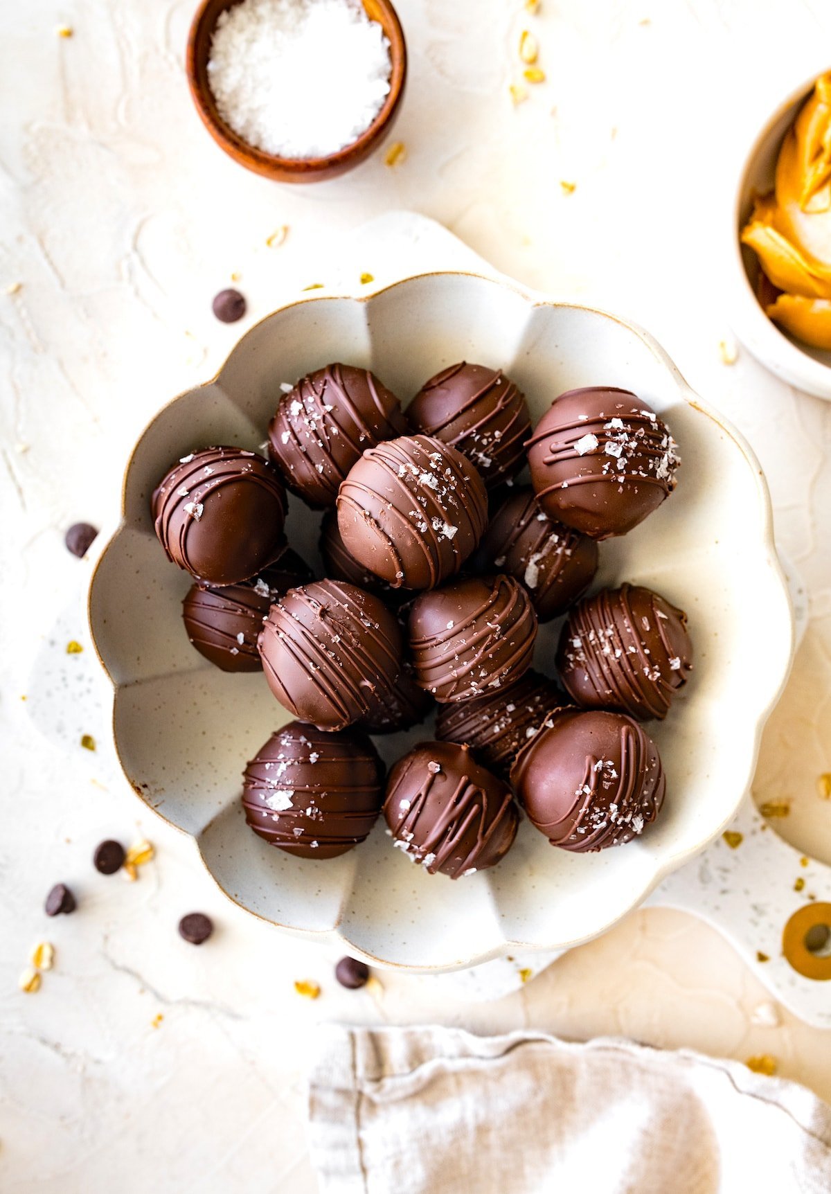 peanut butter protein balls dipped in chocolate on plate.