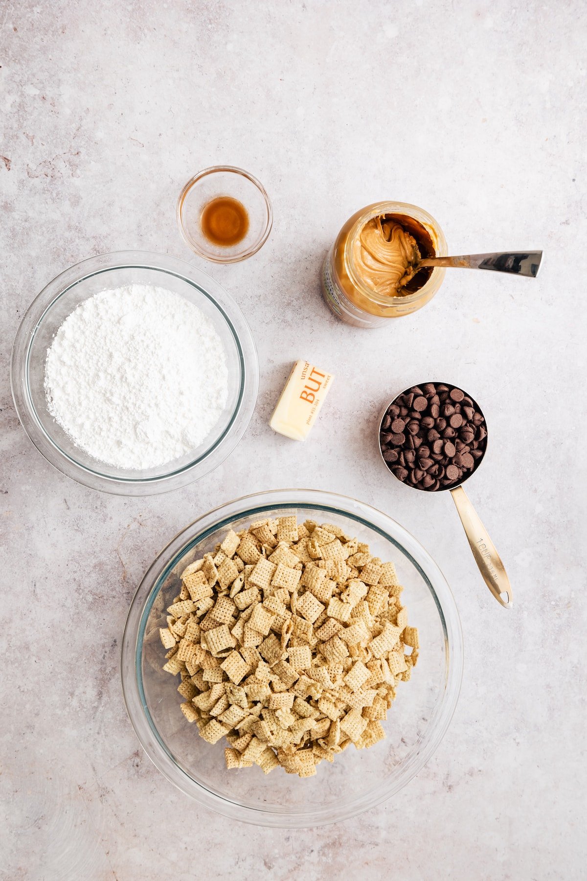 Homemade Puppy Chow is easy to make and SO addicting. This recipe for chocolate peanut butter-covered Chex cereal is a perfect party snack! The ingredients to make homemade puppy chow.