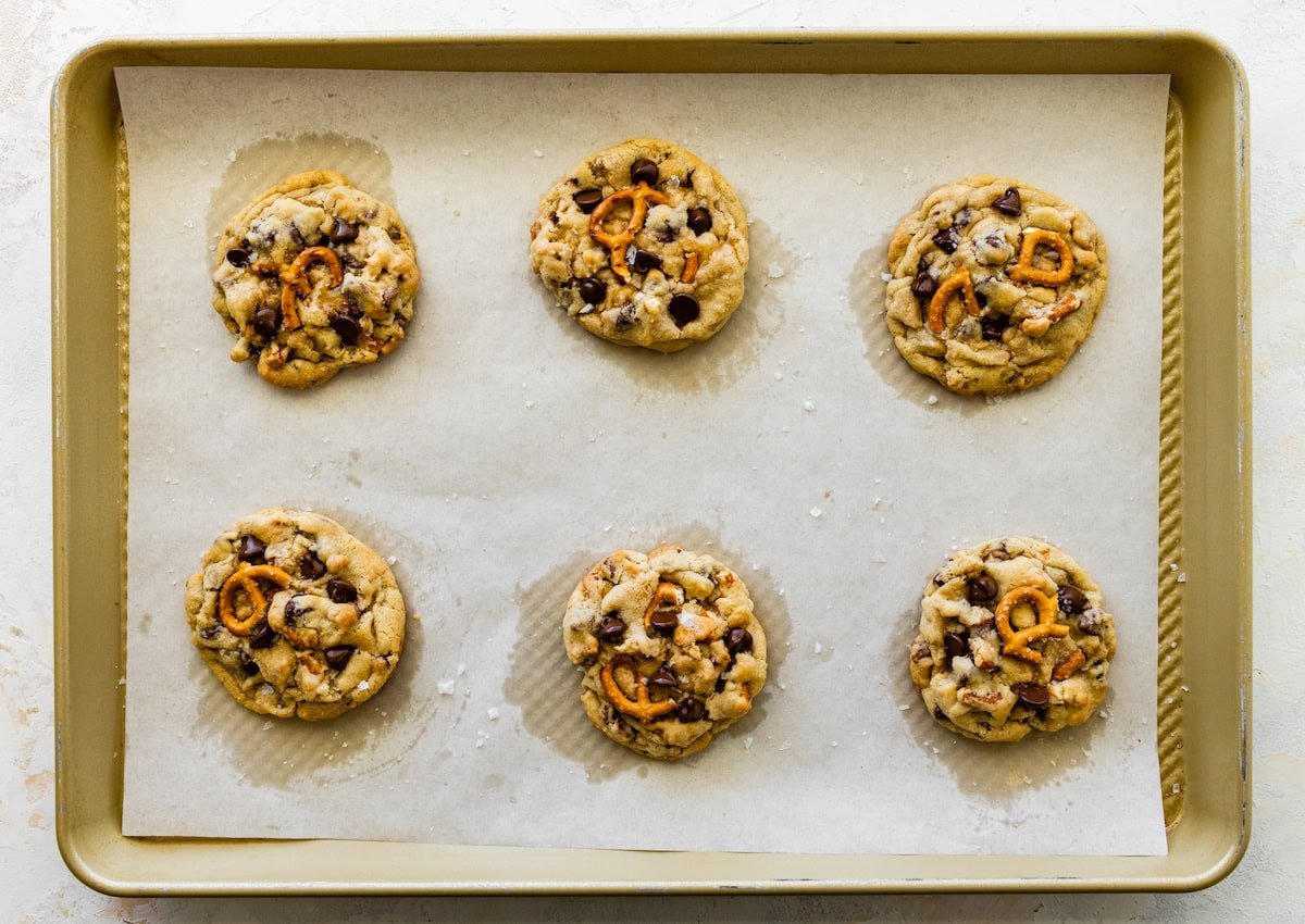 pretzel toffee chocolate chip cookies on baking sheet with parchment paper.
