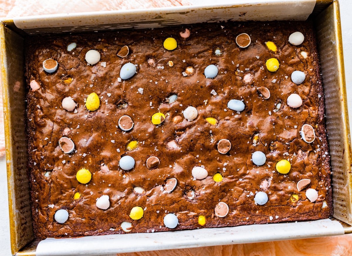 brownies in pan with Cadbury mini eggs. 
