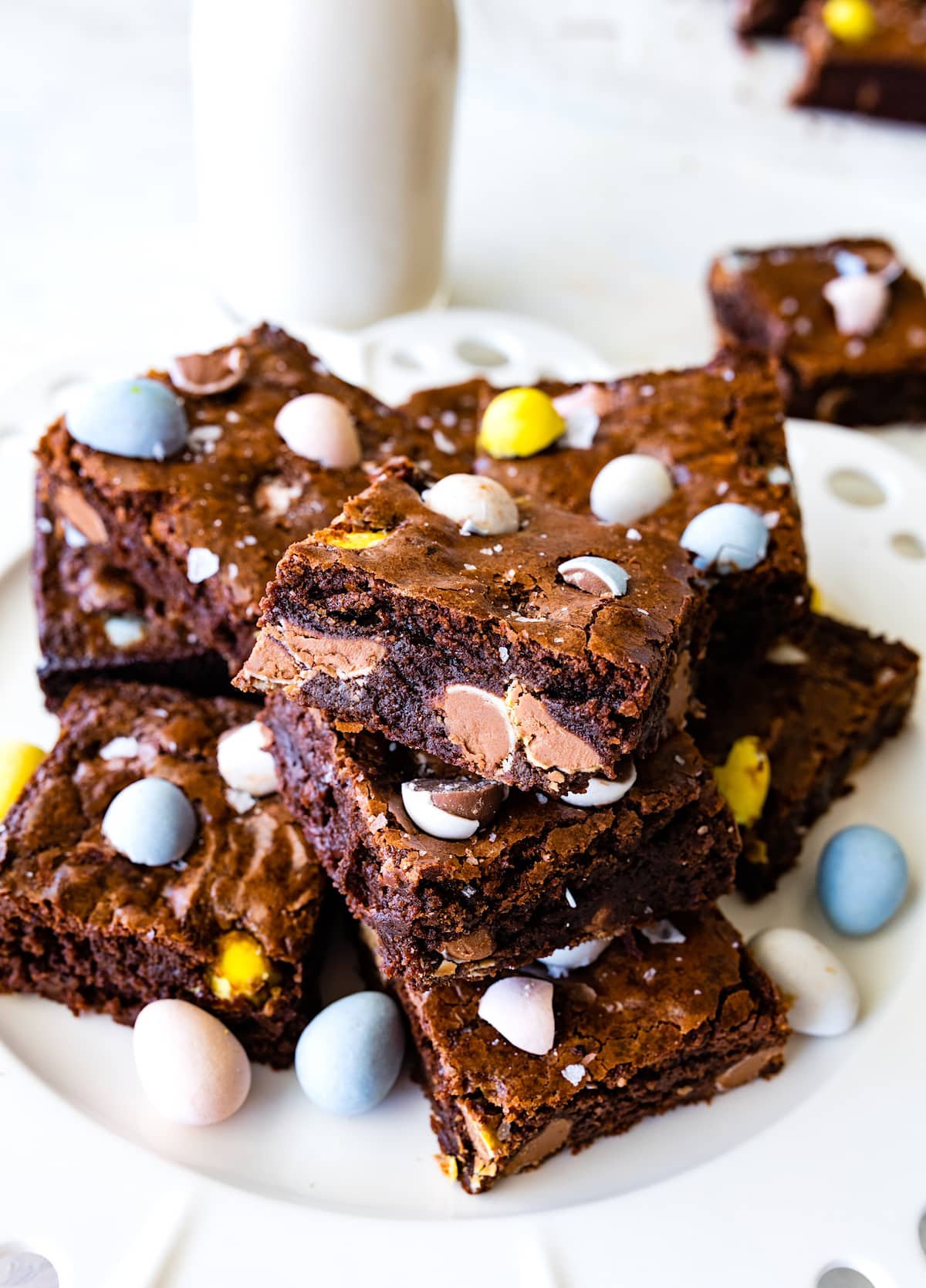 Cadbury egg brownies stacked on plate. 