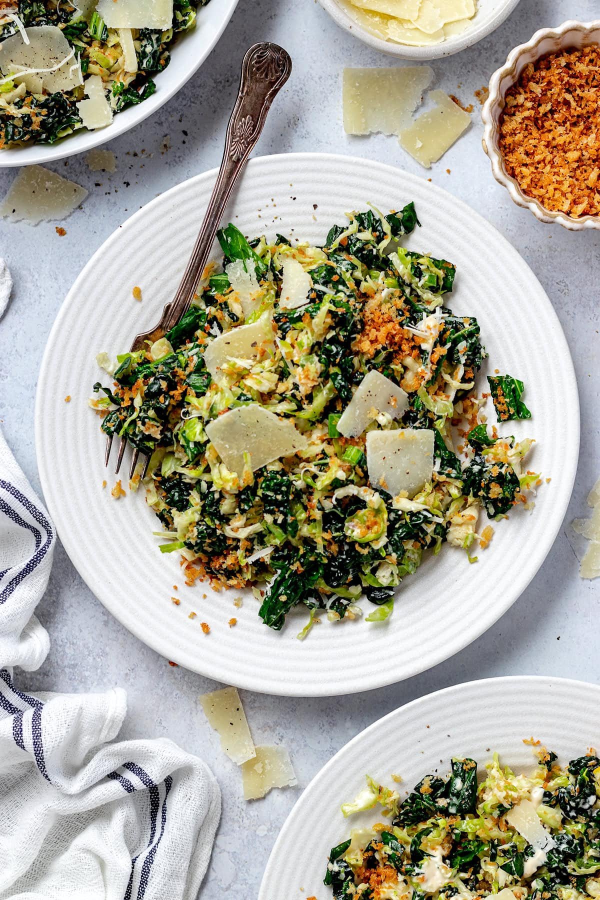 Brussels Sprouts Kale Caesar Salad on plate with fork. 