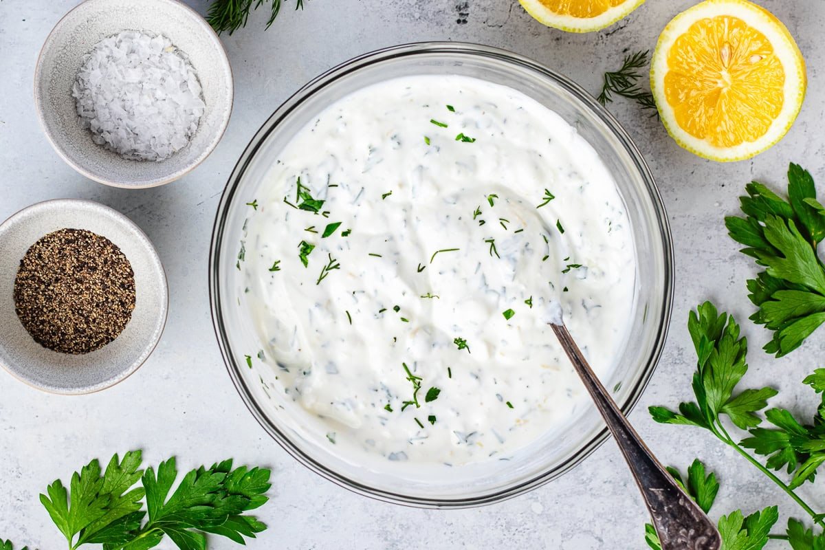 creamy Greek yogurt feta spread in bowl with spoon. 