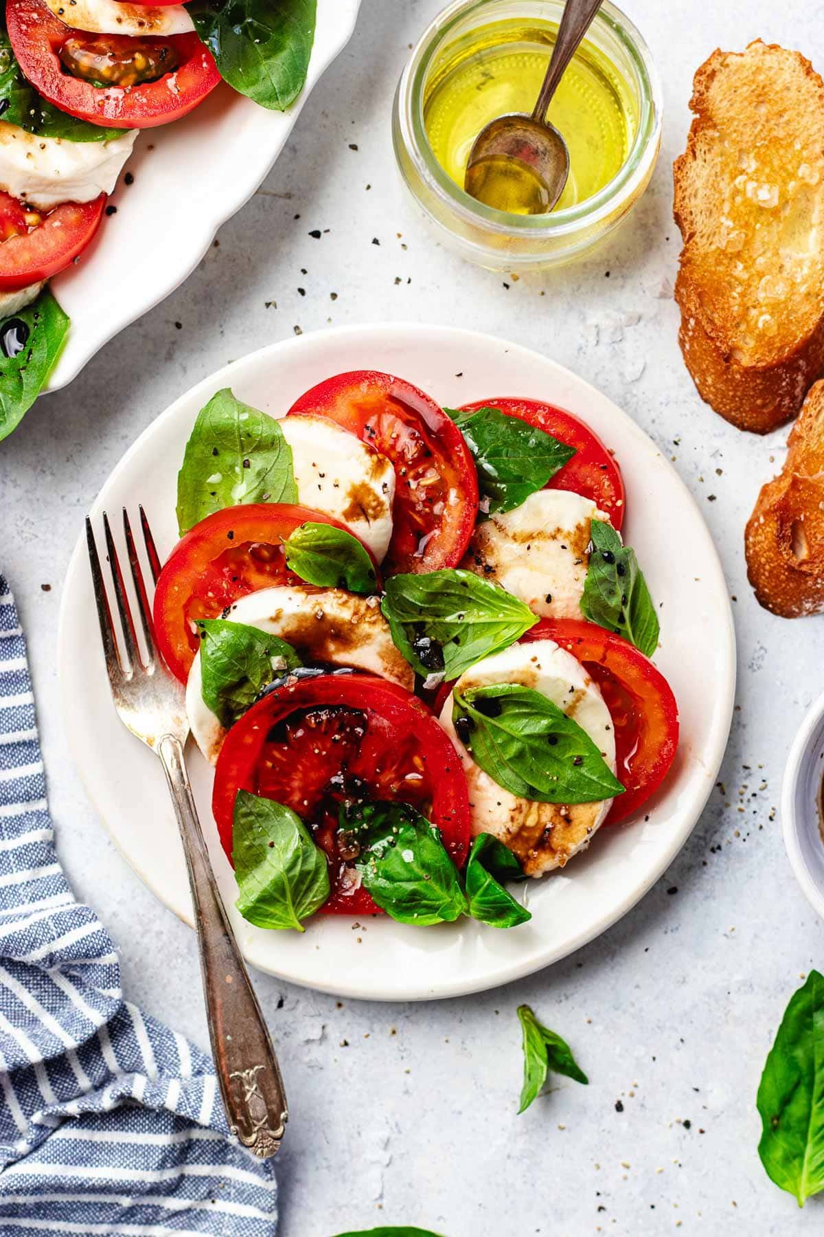 caprese salad on plate with fork. 