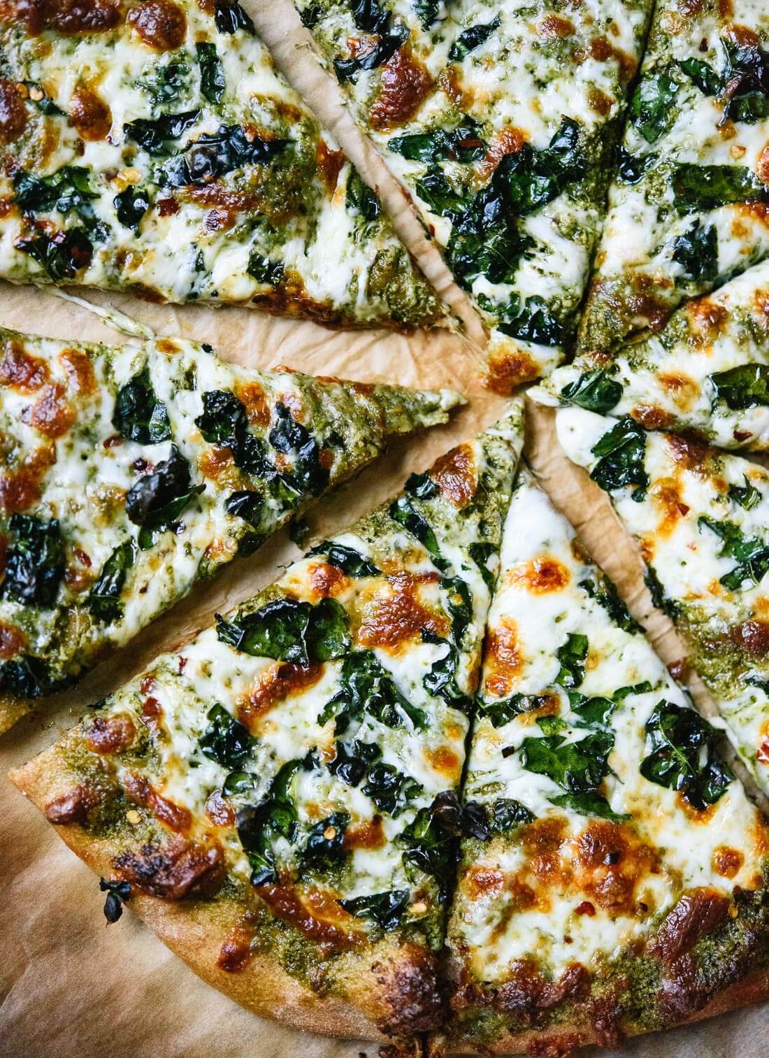 Kale pesto pizza with crispy kale on top! This is a simple weeknight pizza for kale lovers. cookieandkate.com