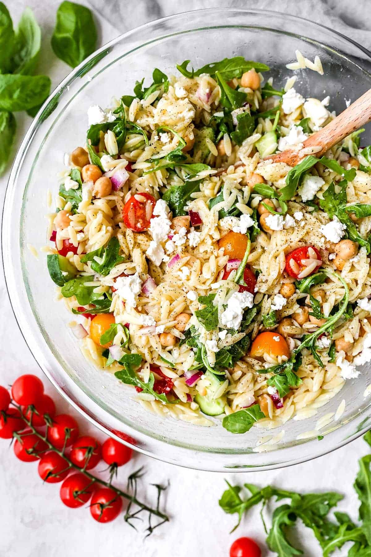 orzo salad in large glass bowl. 