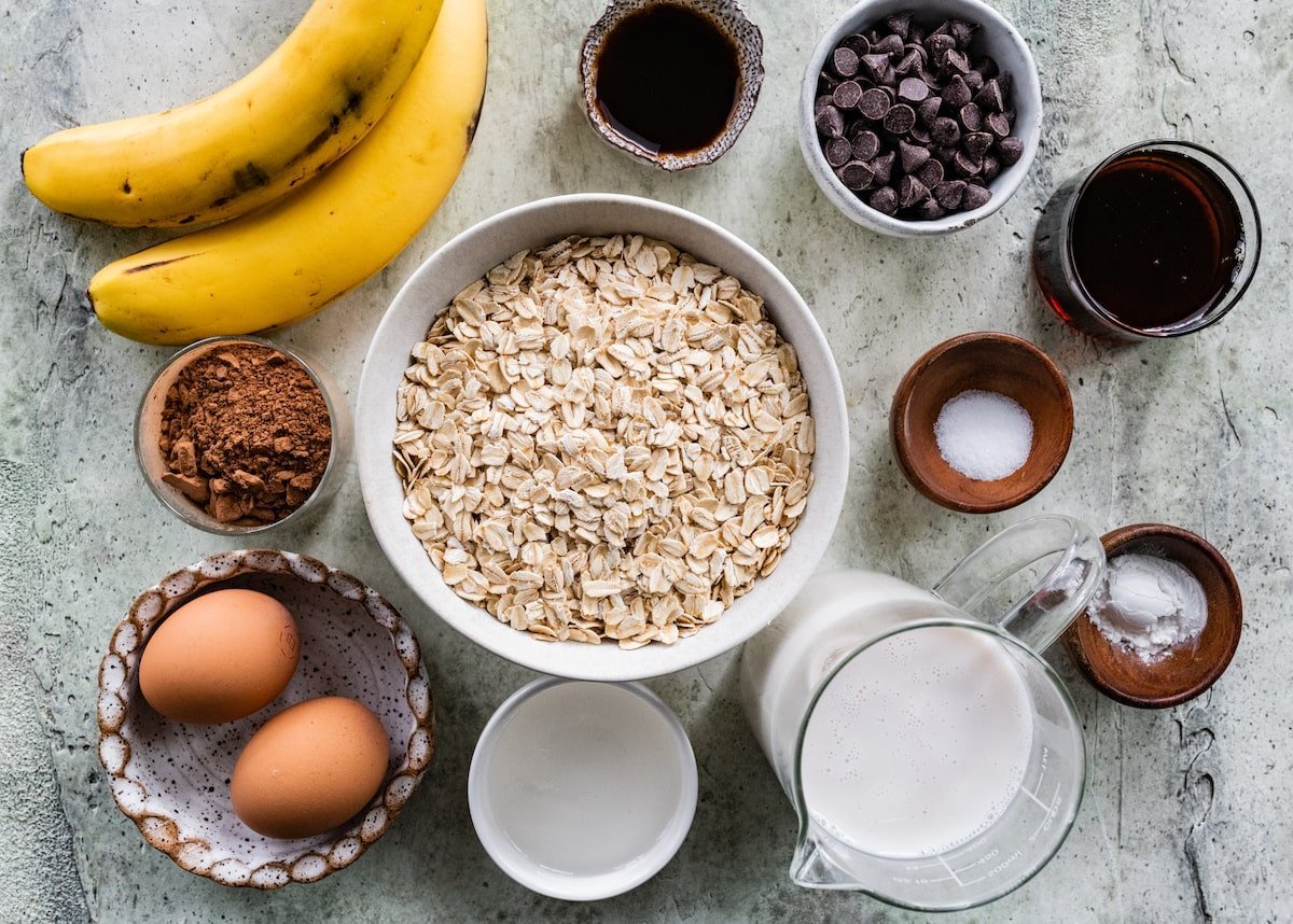 chocolate banana baked oatmeal ingredients in bowls. 
