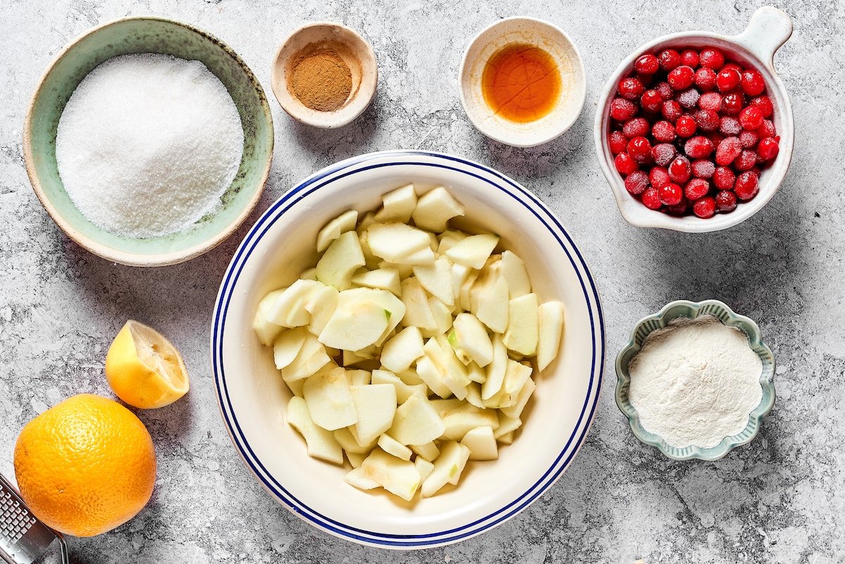 apple cranberry pie filling ingredients in bowls.