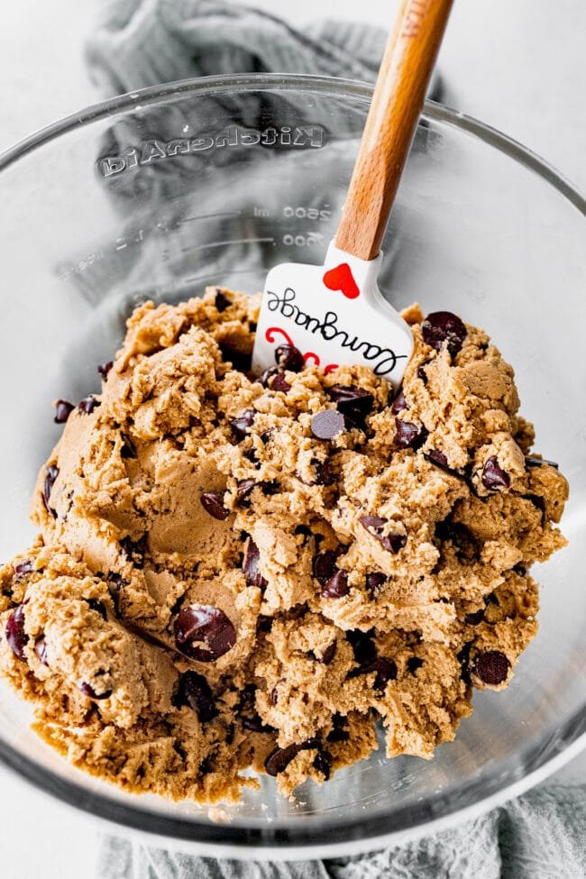 brown butter Biscoff chocolate chip cookie dough in bowl with spatula.