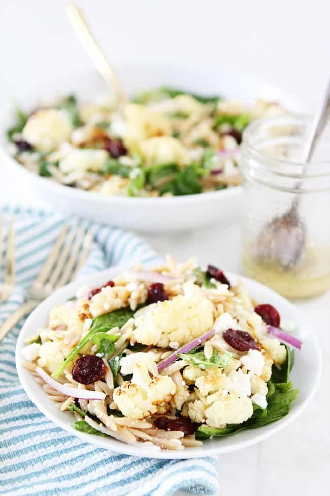 Roasted Cauliflower, Feta, and Orzo Salad Recipe on twopeasandtheirpod.com Spinach salad with roasted cauliflower, orzo, feta cheese, dried cherries, red onion, and a simple honey lemon dressing. Roasted Cauliflower, Feta, and Orzo Salad Recipe