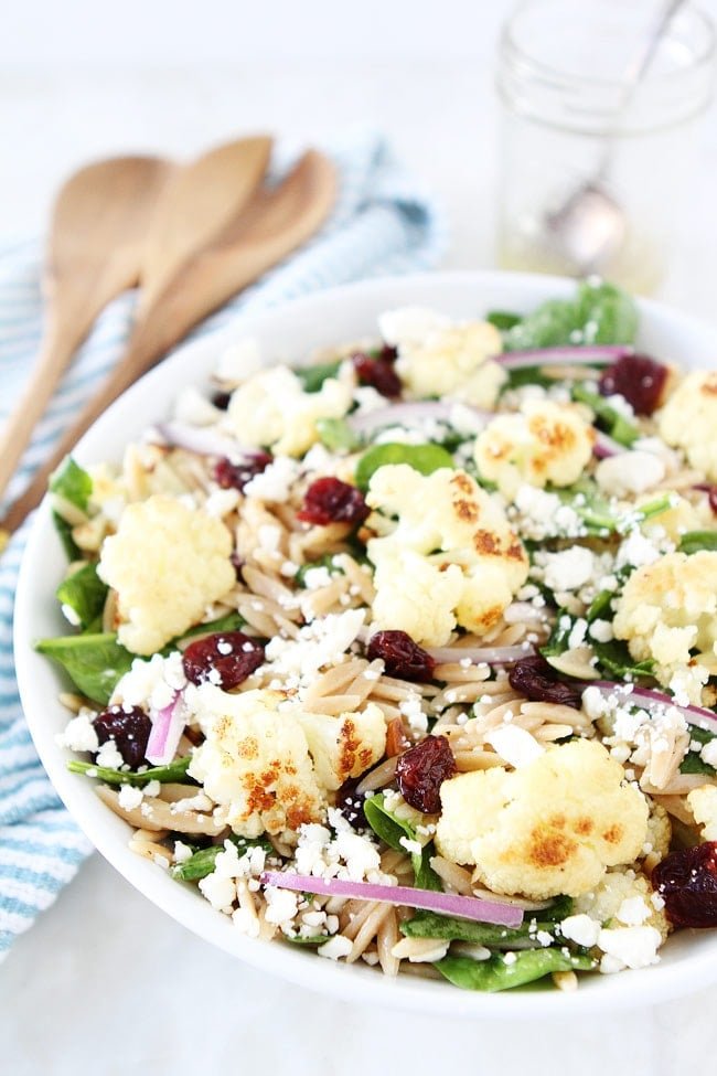 Roasted Cauliflower, Feta, and Orzo Salad Recipe on twopeasandtheirpod.com Spinach salad with roasted cauliflower, orzo, feta cheese, dried cherries, red onion, and a simple honey lemon dressing. Roasted Cauliflower, Feta, and Orzo Salad Recipe