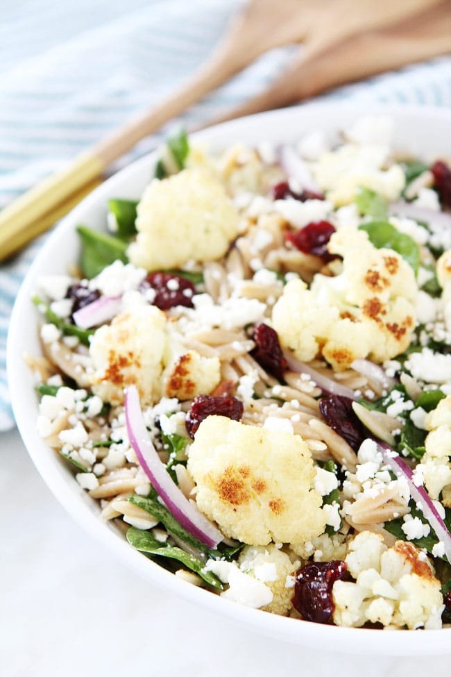 Roasted Cauliflower, Feta, and Orzo Salad Recipe on twopeasandtheirpod.com Spinach salad with roasted cauliflower, orzo, feta cheese, dried cherries, red onion, and a simple honey lemon dressing. This salad goes great with any meal! Roasted Cauliflower, Feta, and Orzo Salad Recipe