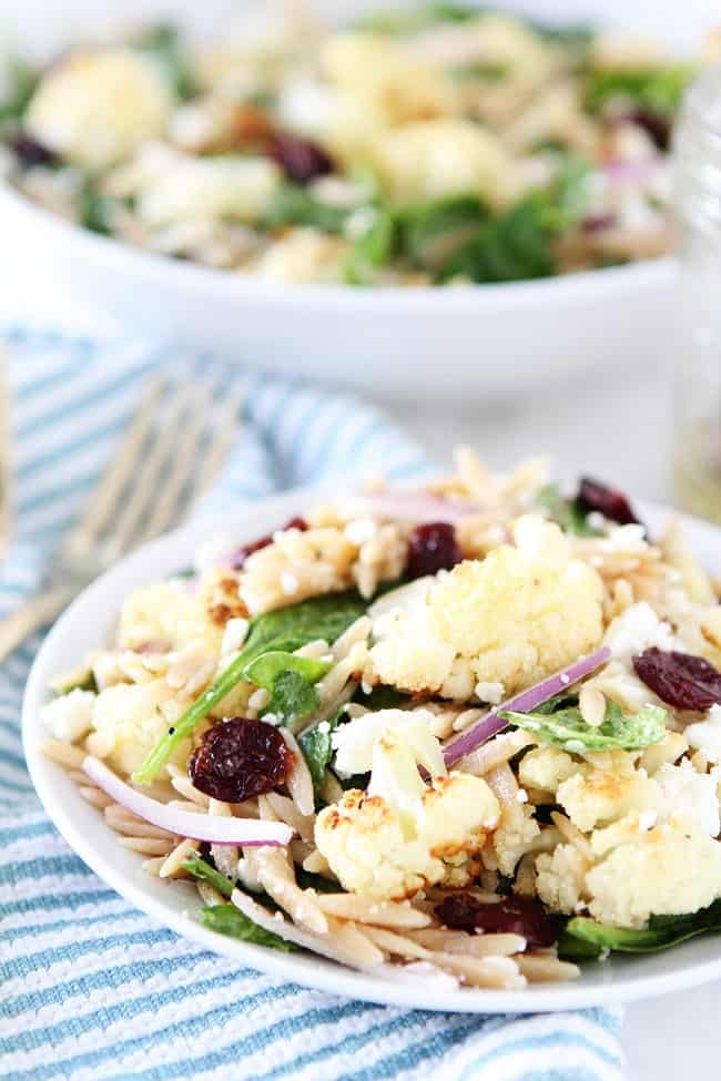 Roasted Cauliflower, Feta, and Orzo Salad Recipe on twopeasandtheirpod.com Spinach salad with roasted cauliflower, orzo, feta cheese, dried cherries, red onion, and a simple honey lemon dressing. Roasted Cauliflower, Feta, and Orzo Salad Recipe