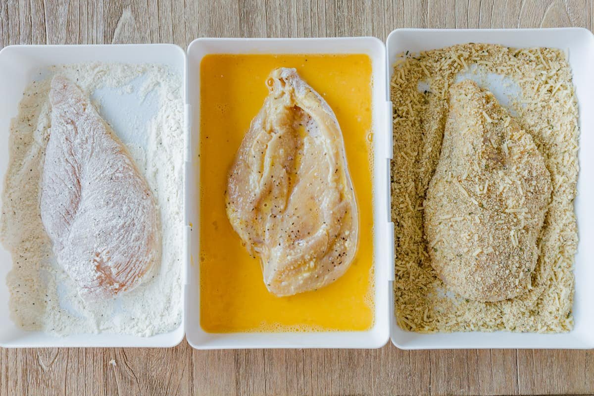 How to bread chicken with parmesan crust for chicken parmigiana Chicken breading bowls with flour, egg and crumb mixture