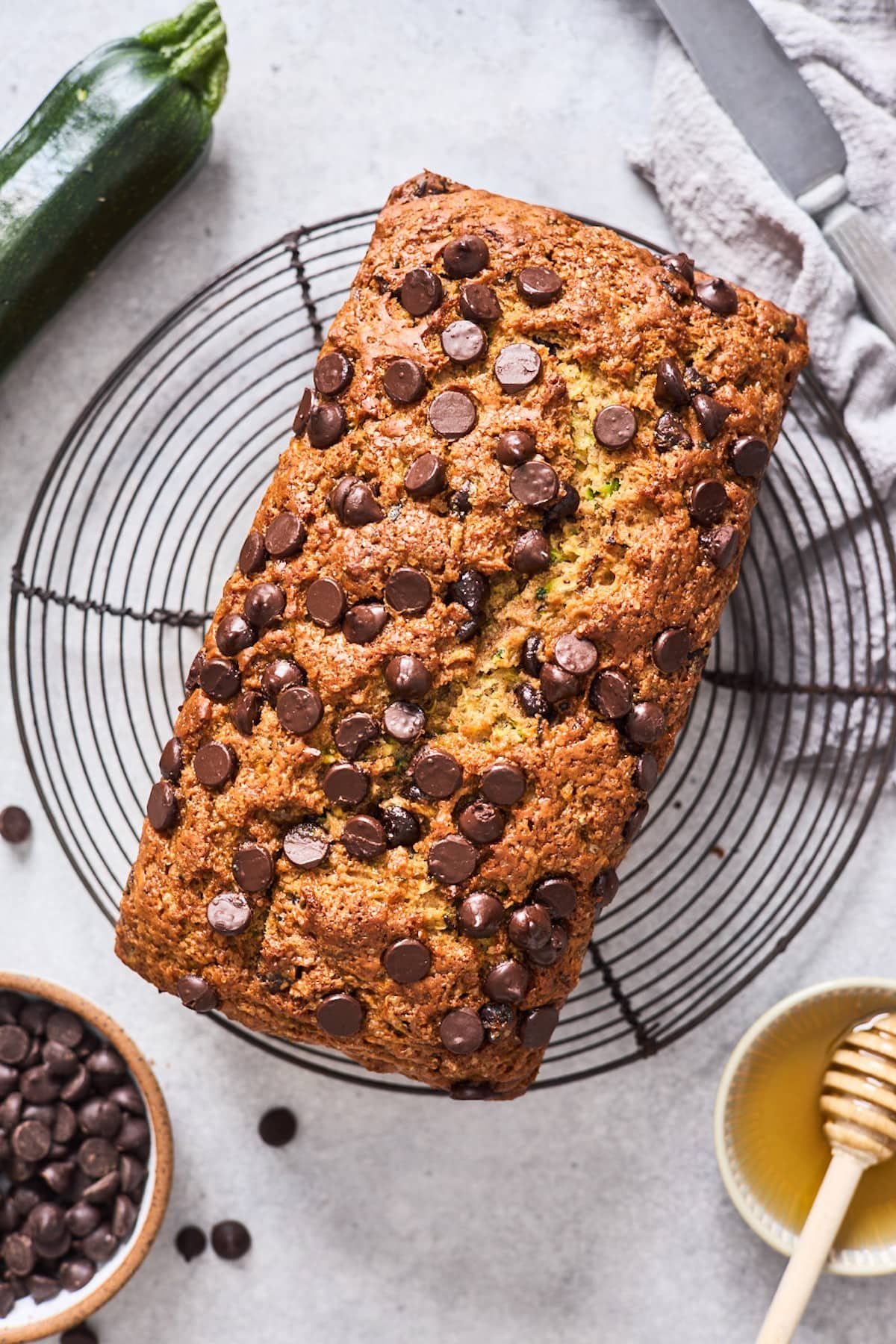 healthy zucchini bread with chocolate chips on cooling rack.