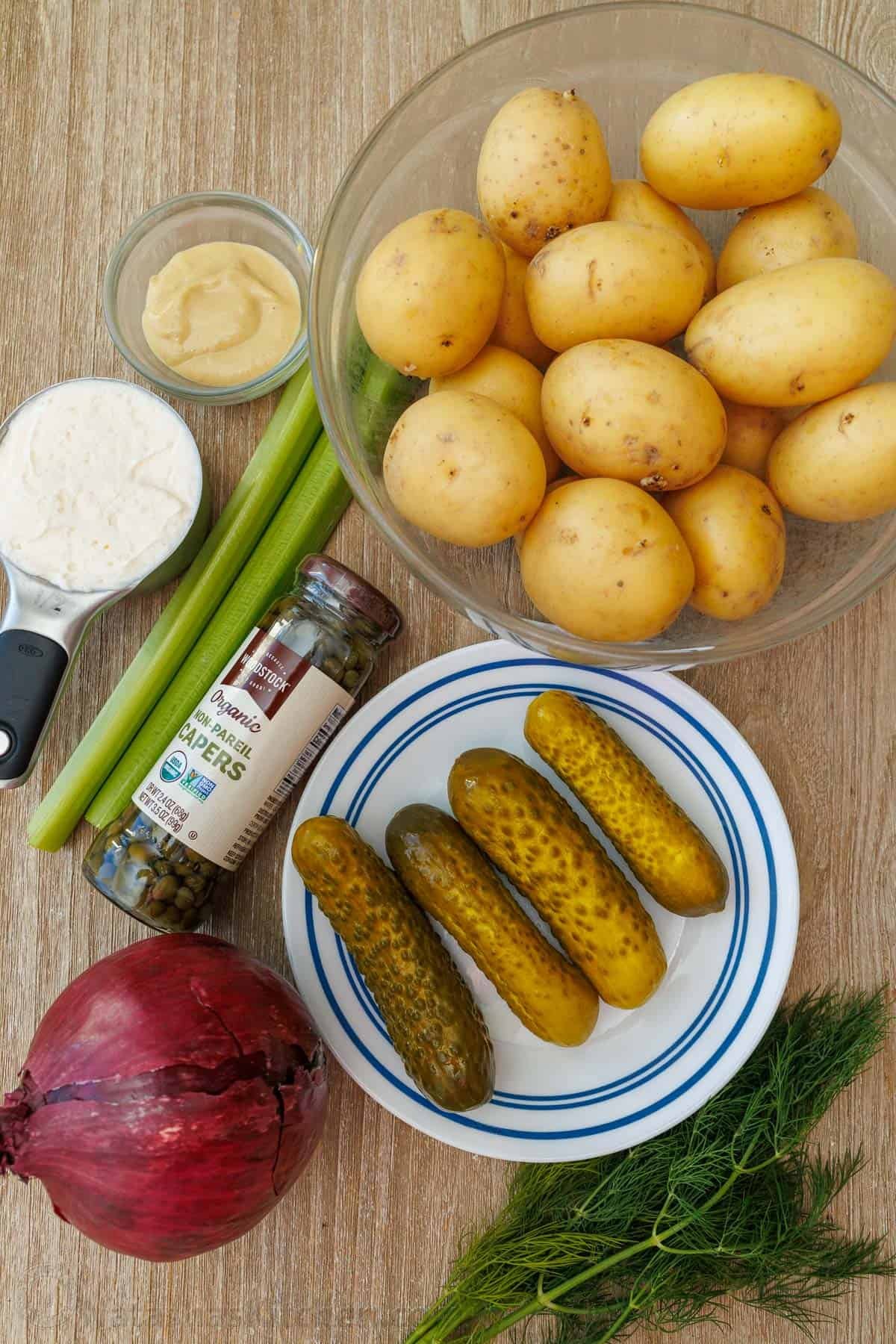 Ingredients for crispy Smashed Potato Salad Ingredients for Smashed Potato Salad: Gold potatoes, dill pickles, dijon mustard, salt and pepper, celery, dill, capers, mayonnaise, red onion, extra virgin olive oil