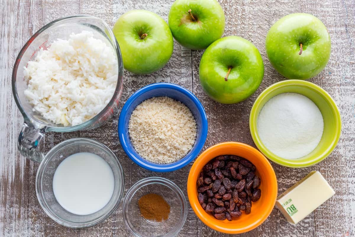 Apple rice pudding is Autumn comfort food. It is loaded with apples, cinnamon and a browned butter crunchy topping. A great way to use leftover white rice! | natashaskitchen.com Ingredients for apple rice pudding with cooked rice, apples, raisins, sugar, cinnamon and bread crumbs