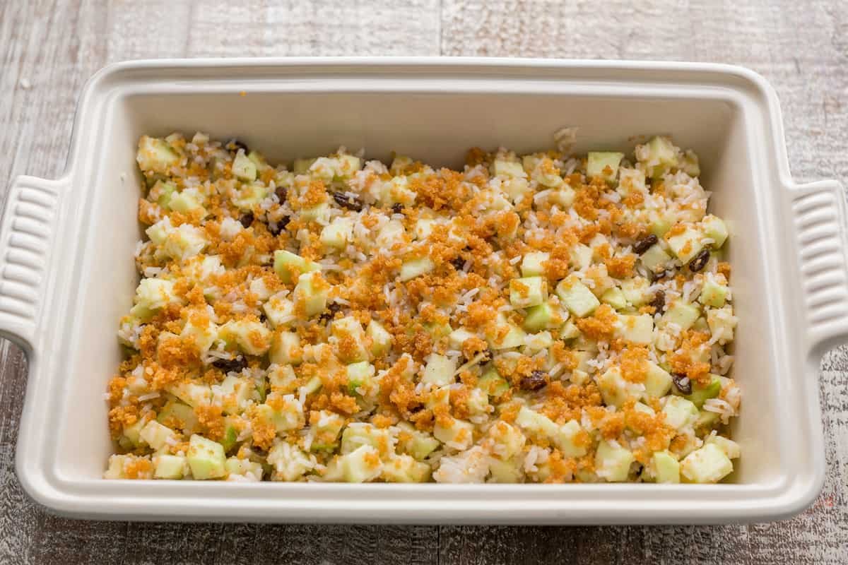 A white tray with apple rice pudding