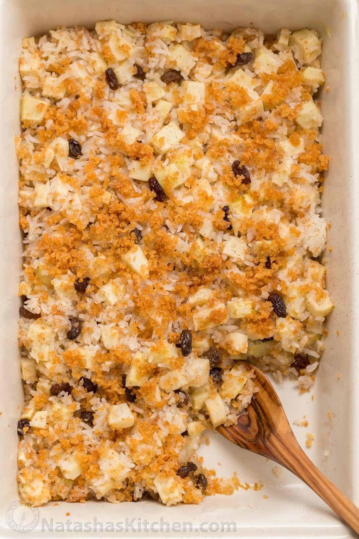 Apple rice pudding is Autumn comfort food. It is loaded with apples, cinnamon and a browned butter crunchy topping. A great way to use leftover white rice! Baked apple rice pudding with a serving removed