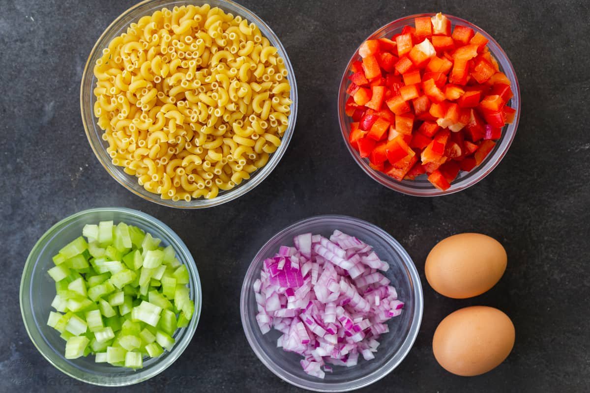 Macaroni Salad is perfect for a summer menu. Paired with BBQ meats, hot dogs, and hamburgers, it's the perfect creamy, refreshing side dish. Ingredients for macaroni salad with elbow macaroni and vegetables