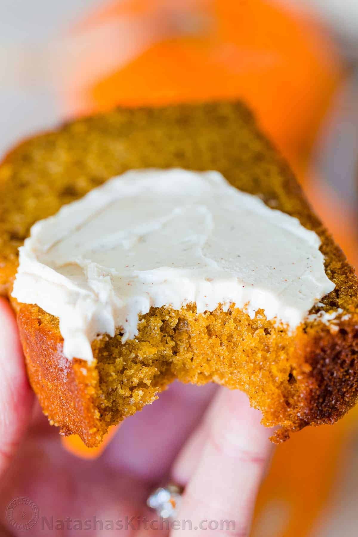 Pumpkin Bread has a soft and moist crumb with wonderful pumpkin flavor. This is our go-to easy pumpkin bread recipe and it's freezer friendly! #pumpkinbread #pumpkinbreadrecipe #easypumpkinbread #pumpkin #pumpkinrecipes #thanksgiving #dessert #bread Honey butter on a slice of fall dessert cake
