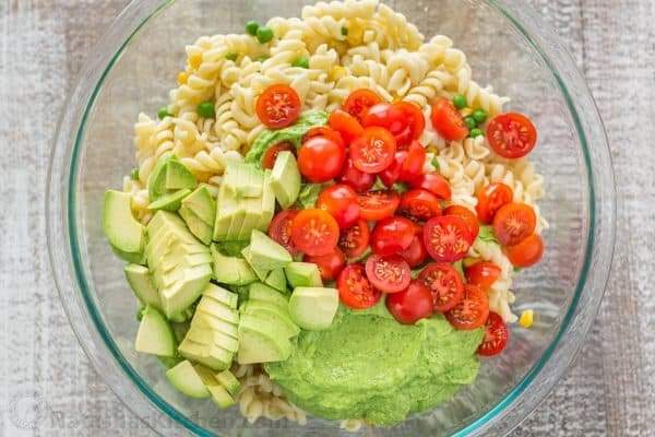 The secret ingredient in this Creamy Avocado Pasta Salad recipe will shock you! This avocado pasta salad is easy, creamy, vibrant, fresh and so satisfying! | natashaskitchen.com